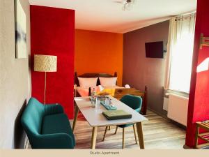 a room with a table and chairs and a bed at Trattoria & Apartments - Casa da Enzo in Goslar +18 photos
