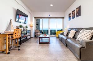 a living room with a couch and a table at Beachfront Condo with Balcony amazing view in Tijuana