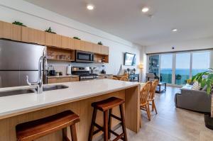 a kitchen with a counter and a kitchen with a living room at Beachfront Condo with Balcony amazing view in Tijuana