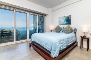 a bedroom with a bed with a view of the ocean at Beachfront Condo with Balcony amazing view in Tijuana +34 photos
