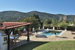 a backyard with a swimming pool and a house at Villa Pefka in Skiathos