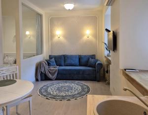 a living room with a blue couch and a table at M.K. Čiurlionis 7 in Vilnius