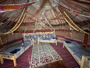 a room with two beds in a yurt at Khansar Family Yurt Camp in Elʼtay +20 photos