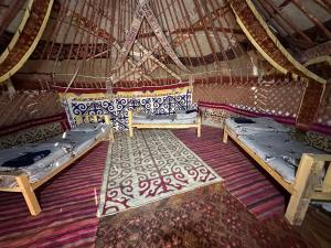 a room with two beds in a yurt at Khansar Family Yurt Camp in Elʼtay
