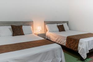 Voodi või voodid majutusasutuse Hotel Cafetto toas