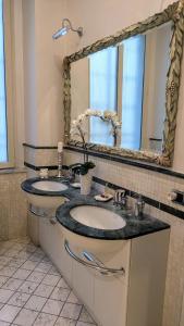 a bathroom with two sinks and a large mirror at Suite Ottocento napoletano in Naples