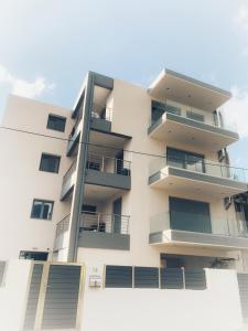 an apartment building with balconies on the side of it at Comfy Vista Apartment in Kalamata +69 photos