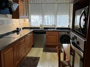 a kitchen with a sink and a washing machine at Villa Laura in Boó de Piélagos