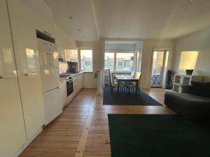 a kitchen and living room with a table and a couch at Harbour Residence in Copenhagen