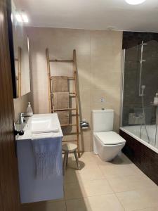 a bathroom with a sink and a toilet and a shower at Mas Gelabertó in GRO +22 photos