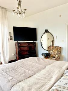 a bedroom with a large bed and a mirror at MyPuglia, Central Sea-View Suites in Brindisi in Brindisi