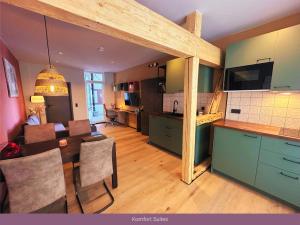 a kitchen and living room with a table and a dining room at Trattoria & Apartments - Casa da Enzo in Goslar