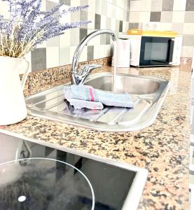 a kitchen sink with a towel sitting on it at Imperial Villas I Casa Yei in Puerto del Carmen +4 photos