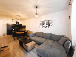 a living room with a couch and a table at ORBIS Central apartment in Nitra