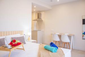 a living room with a couch and a table with fruit on it at Aparthotel al centro de Peñiscola - Mar de Cristal in Peñíscola +57 photos