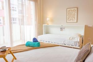 a bedroom with a bed and a large window at Aparthotel al centro de Peñiscola - Mar de Cristal in Peñíscola