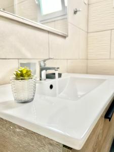a bathroom with a white sink and a mirror at Imperial Villas I Casa Yei in Puerto del Carmen