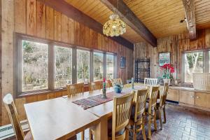 a dining room with a long table and chairs at Mountain Valley Hideaway in Aspen