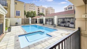 a swimming pool in a yard with a fence at Homely 3 Bedroom apartment in Villa Italia Century City in Cape Town
