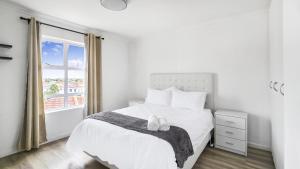 a bedroom with a white bed and a window at Homely 3 Bedroom apartment in Villa Italia Century City in Cape Town +31 photos