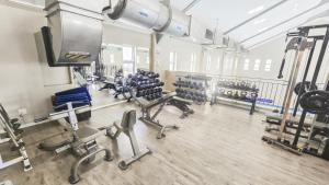 a gym with several rows of chairs and machines at Homely 3 Bedroom apartment in Villa Italia Century City in Cape Town