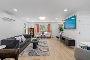a living room with a couch and a table at Riverfront Retreat in Wareham in Wareham