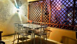 a table and chairs in a room with a wine cellar at Vila Bulgaru in Cumpăna