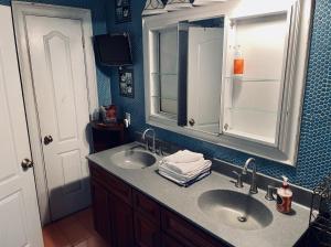 a bathroom with two sinks and a mirror at NYC Townhouse Apartment in New York