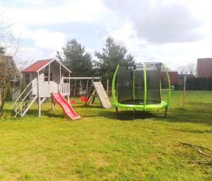 a playground with a slide and a swing set at kraina jezior in Skorochow