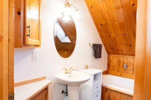 a bathroom with a sink and a mirror at Get A Way Beach Chalet in Cocagne  +35 photos