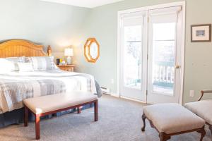 a bedroom with a bed and a chair and a window at Get A Way Beach Chalet in Cocagne 