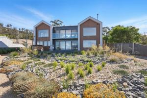 a house on a hill with a garden at Modern Coastal Retreat and Hot Tub in Carlton