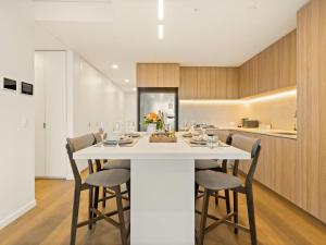 a dining room with a white table and chairs at 2BR West End Apt with Parking Walk to Convention Ctr in Brisbane