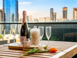 a bottle of wine sitting on a table with glasses at 2BR West End Apt with Parking Walk to Convention Ctr in Brisbane