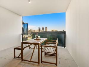 a table and two chairs on a balcony with a view at 2BR West End Apt with Parking Walk to Convention Ctr in Brisbane