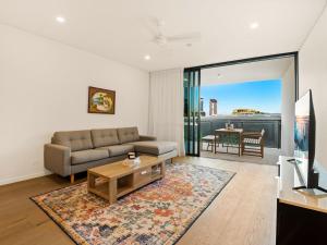 a living room with a couch and a table at 2BR West End Apt with Parking Walk to Convention Ctr in Brisbane
