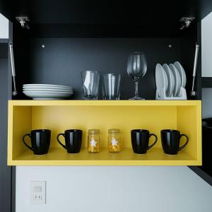 a yellow shelf with plates and cups and glasses at The Sunny Loft Coronado Ph Ibiza in Playa Coronado