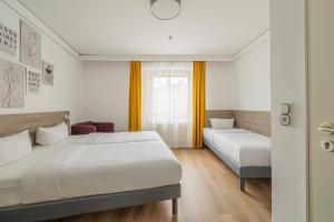 Postel nebo postele na pokoji v ubytování Hotel Gute Hoffnung Pforzheim