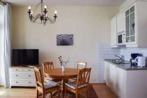 a kitchen and dining room with a table and chairs at Fürstenhof Sassnitz in Sassnitz
