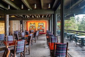 a dining room with chairs and tables in a building at Glacier Bay Lodge in Gustavus