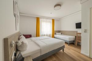Postel nebo postele na pokoji v ubytování Hotel Gute Hoffnung Pforzheim