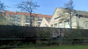 a fence in front of a building with buildings at Harbour Residence in Copenhagen +8 photos