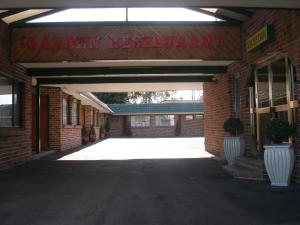 an entrance to a brick building with a sign on it at Mt Kuring-Gai Motel in Mount Kuring-Gai