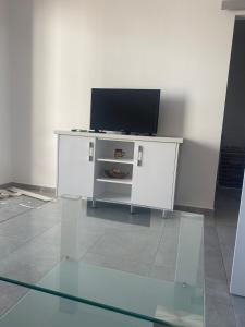 a white cabinet with a television on top of it at Beachfront, 2 Bed with Sea Views in Elenite