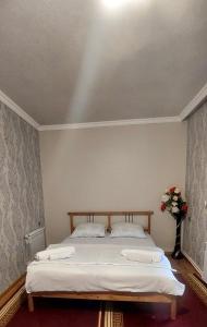 a bedroom with a bed with two white pillows at Lovely family, Spacious room, City Center apartmen in Sheki