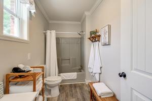 a white bathroom with a toilet and a shower at Bring Your Boat Retreat Near Lake Guntersville in Guntersville +16 photos