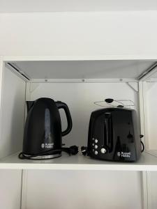 two toasters and a toaster sitting on a shelf at Ferienwohnung Alte Brauerei in Leipzig