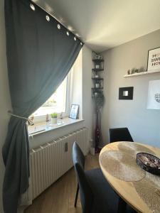 a dining room with a table and a window at Sweet Home in Klagenfurt