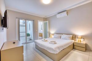 a bedroom with a bed with two towels on it at Unique two bedroom apt with huge outdoor area and close to entertainment in Is-Swieqi