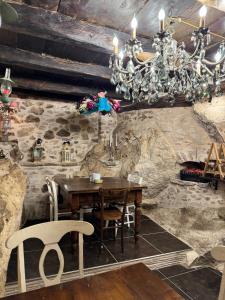 a dining room with a table and a chandelier at Il Vicoletto in Artena